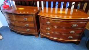 A pair of mahogany bow front chest of drawers, with brushing slides, above three long drawers