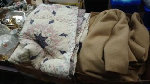 Various quilts and vintage coats