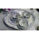 Meat strainer and plate and three blue and white tea cups and saucers