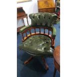 A green leather Chesterfield office chair