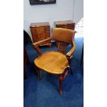 A 1930's oak office chair, with slatted and solid back