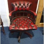 A red Chesterfield button back office chair