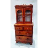 A miniature chest of drawers, with bookcase top