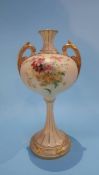 A Royal Worcester vase with two gilt handles decorated with sprays of flowers, puce marks,