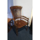 A mahogany office chair, with slatted back, curving arms, the whole supported on turned legs