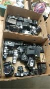 A large quantity of cameras in two boxes