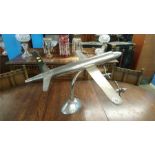 A large metalwork model aeroplane and stand, 79cm long and 86cm wingspan