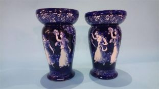 A pair of Royal Doulton 'Morrisian' vases on a blue ground, decorated with dancing girls, numbered