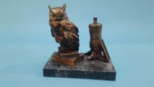 A table lighter in the form of an Owl resting on books