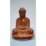 A bronze model of a seated Buddha on stand. 17cm high