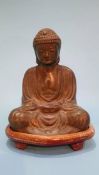 A bronze model of a seated Buddha on stand. 17cm high