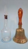 An 'ARP' hand bell and a clear glass decanter