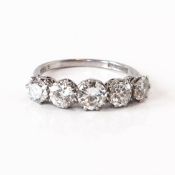 A platinum ring set with five round cut diamonds, assessed colour F-G, clarity VS - SI; total weight