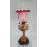 A Victorian oil lamp, with cranberry and etched glass shade