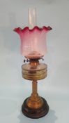 A Victorian oil lamp, with cranberry and etched glass shade