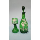 A green glass decanter painted with enamels and matching goblet