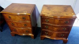 A pair of walnut serpentine chests of three drawers, 53cm wide