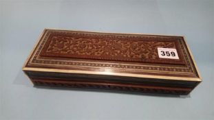 A carved hardwood Oriental glovebox and contents