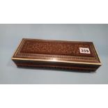 A carved hardwood Oriental glovebox and contents