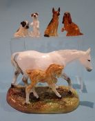 A Royal Doulton horse group, HN 2532 and four miniature Royal Doulton dogs