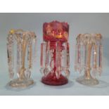 A pair of table lustres and a single cranberry glass lustre