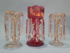 A pair of table lustres and a single cranberry glass lustre