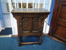 An oak single door cabinet, 61cm wide