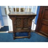 An oak single door cabinet, 61cm wide