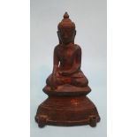 A small bronze figure of a seated Buddha sitting crossed legged. 16cm high