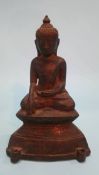 A small bronze figure of a seated Buddha sitting crossed legged. 16cm high