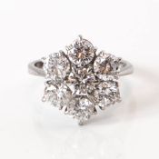 An 18ct white gold cluster ring, set with seven diamonds, assessed colour F-H, clarity SI, total