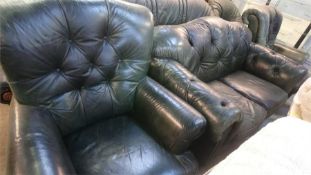 A green leather Chesterfield style three piece suite