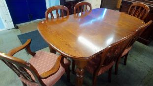 An oak Victorian style table and six chairs