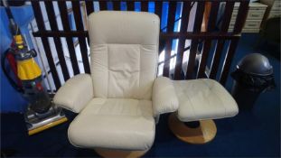 A cream leather armchair and stool