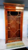 A narrow yew wood cabinet