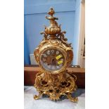 A brass Urgos mantle clock