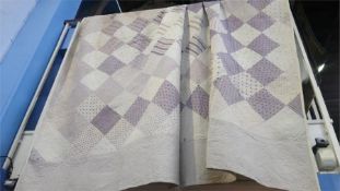 A pale purple with cream reverse quilt