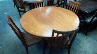 A teak G Plan circular table and a set of four chairs