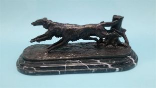 A reproduction bronze of two dogs hunting