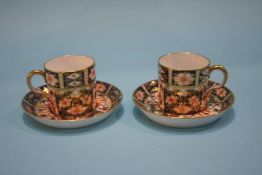 Two Royal Crown Derby coffee cans and saucers, numbered 2451