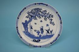 A blue and white plate decorated with children and bats, marks in underglaze blue. 16.5cm diameter