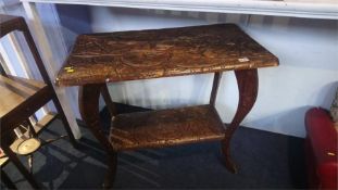 A carved two tier occasional table