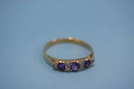 An 18ct gold ring set with amethyst and diamonds