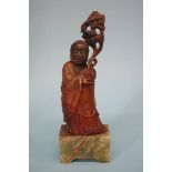A carved horn figure of a Chinese gentleman on an onyx base. 23cm high