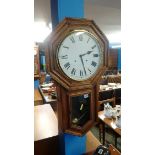 An oak wall clock with octagonal case, painted dial and eight day movement