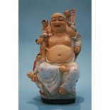 An Oriental figure of Buddha, 34cm high