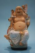 An Oriental figure of Buddha, 34cm high