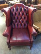 A red leather Chesterfield armchair