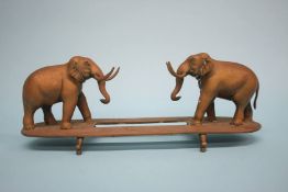 A pair of bronze elephants on stand. 34cm wide