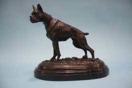 A reproduction bronze model of a standing dog